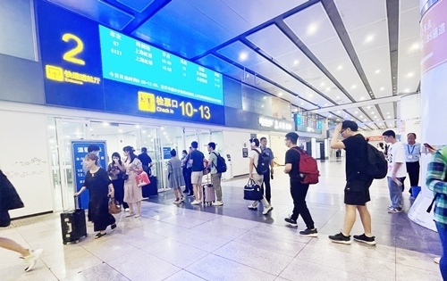 在快速進(jìn)站廳前排隊(duì)等待檢票的旅客。人民網(wǎng)記者 喬雪峰攝