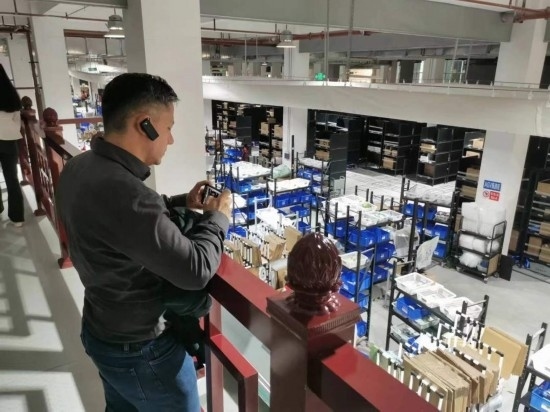 2023“一帶一路”媒體合作論壇聯(lián)合采訪團(tuán)團(tuán)員在仁和醫(yī)藥物流園拍攝記錄轉(zhuǎn)運(yùn)流程。（本報(bào)記者 黃超攝）