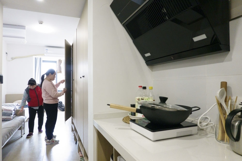 住戶在閔行區(qū)新時(shí)代城市建設(shè)者管理者之家收拾房間。