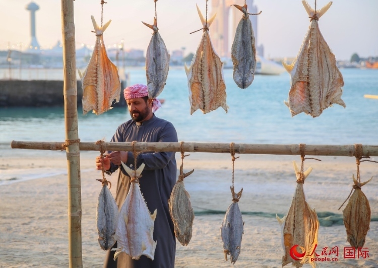  手工藝者展示如何晾曬魚干。人民網(wǎng) 塔里克·易卜拉欣攝