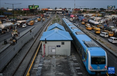 3月4日，在尼日利亞拉各斯，一列輕軌藍(lán)線列車行駛至公路交通擁堵路段附近。新華社記者 韓旭 攝